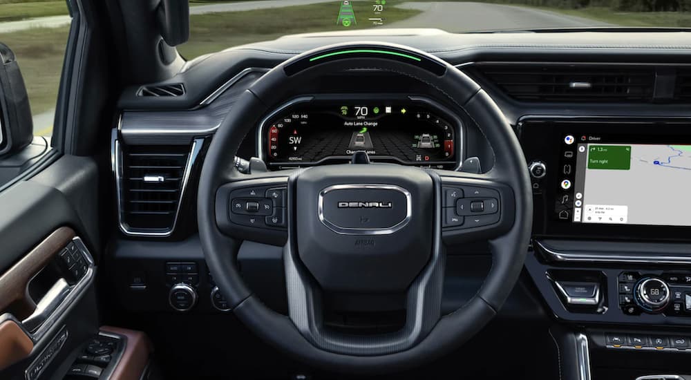 The black interior and dash of a 2023 GMC Sierra 1500 Denali is shown.