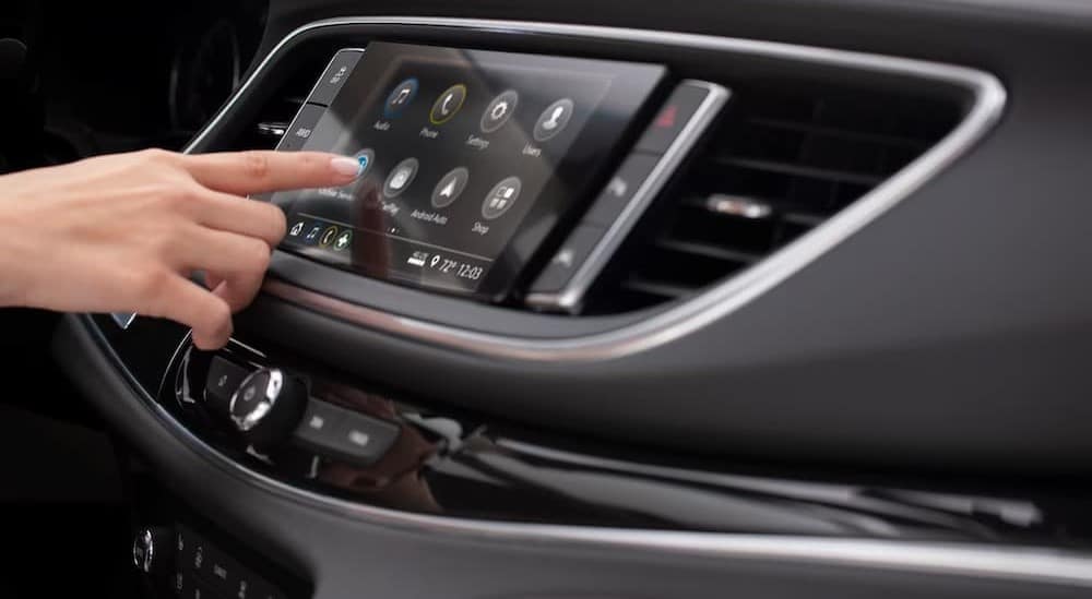 A close-up of the infotainment screen is shown in a 2024 Buick Enclave.