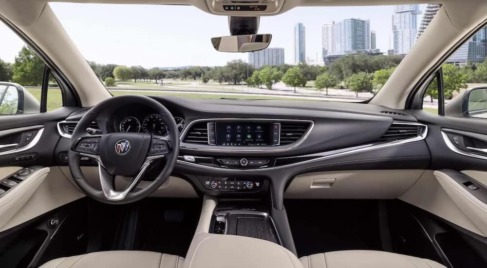 The black and creme interior and dash of a 2024 Buick Enclave is shown.